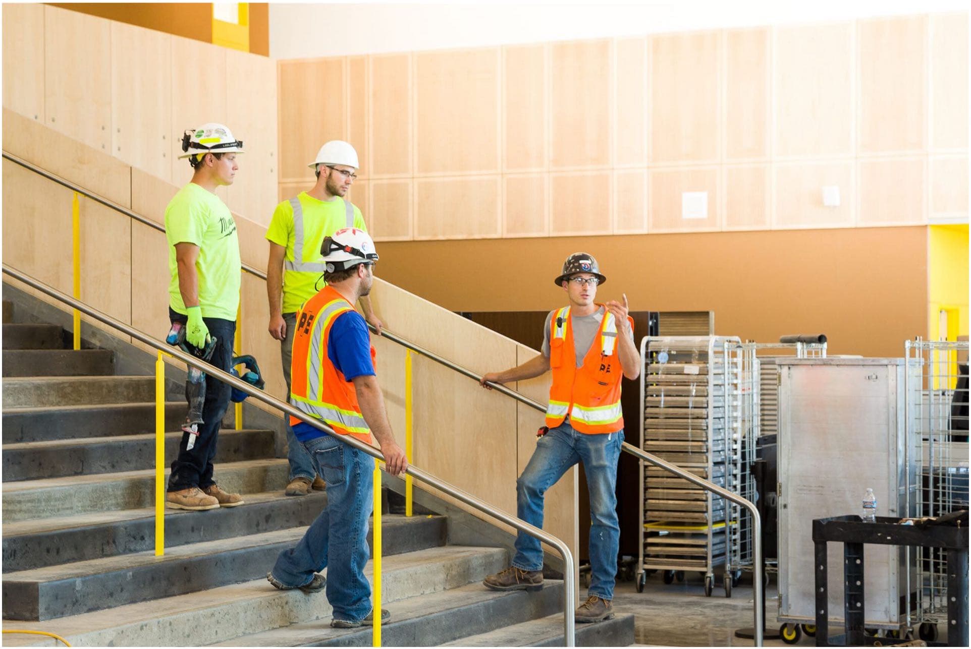 Workers discussing a project in a large room to illustrate Commercial Maintenance and Troubleshooting