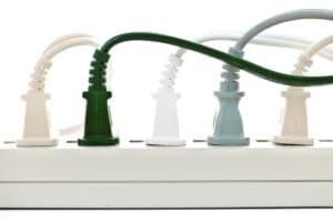 Surge protector (used to prevent power outages) with several cords plugged in