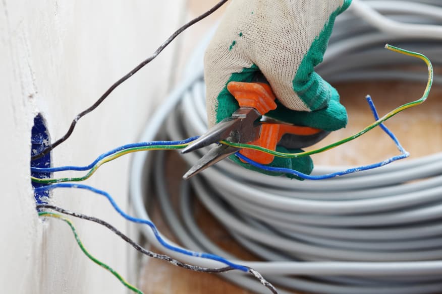 In Vancouver, WA, an electrician is skillfully cutting wires with his precision tools for residential electrical work.