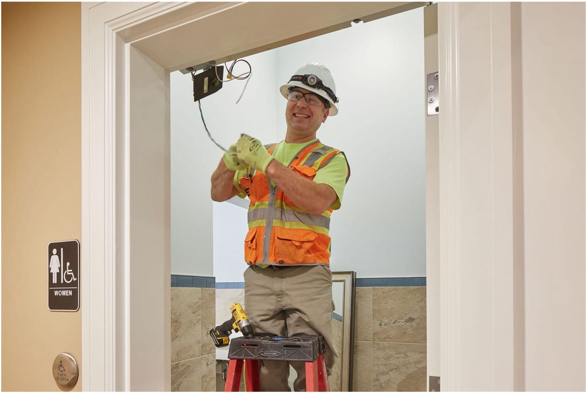 Workers discussing a project in a large room to illustrate Commercial Maintenance and Troubleshooting