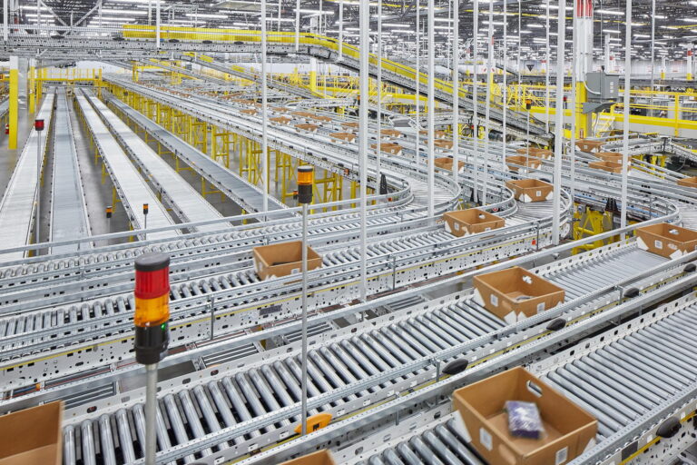 Located in Troutdale, OR, the industrial distribution center features numerous conveyor belts and bright overhead lighting for efficient package handling. If you need professional electrical services to maintain or enhance this setup in nearby Vancouver, WA, contact our expert electricians today.