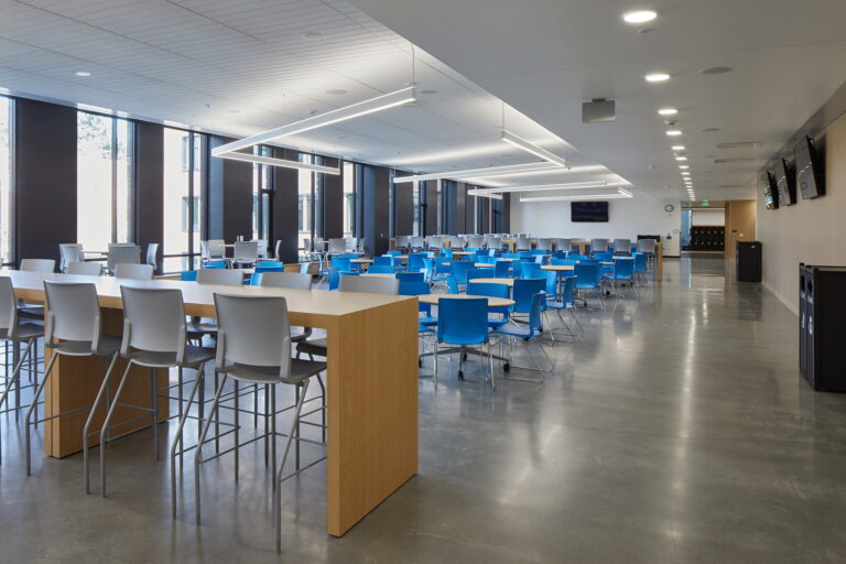 At Grant High School in Portland, OR the cafeteria showcases modern amenities like wall-mounted monitors and large windows that let in natural light. For any electrical installation or maintenance needs, including lighting and monitor setups, our professional electrician services are here to ensure everything is up to code and functioning smoothly.