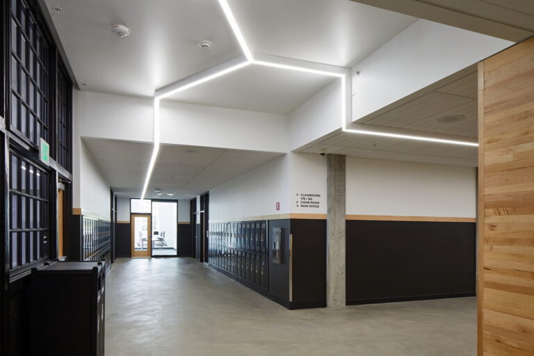 Grant High School in Portland, OR features modern hallway lighting with linear LED lights installed by our professional electricians. These energy-efficient solutions ensure well-lit corridors for enhanced safety and aesthetics. Contact us for expert electrician services tailored to your needs.