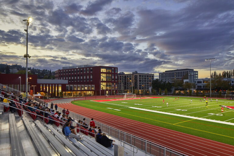 Under the cloudy evening sky in Portland, OR, Lincoln High School's sports field buzzes with activity. As players compete and spectators cheer, the partially lit stadium highlights the need for reliable electrician services.