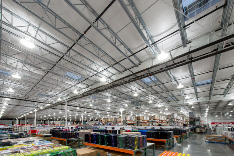 The interior of the Bellingham Costco Warehouse features high ceilings and bright lighting, ideal for showcasing stocked shelves of bulk items. For professional electrician services to ensure optimal lighting in similar commercial spaces in Vancouver, WA, contact our team.