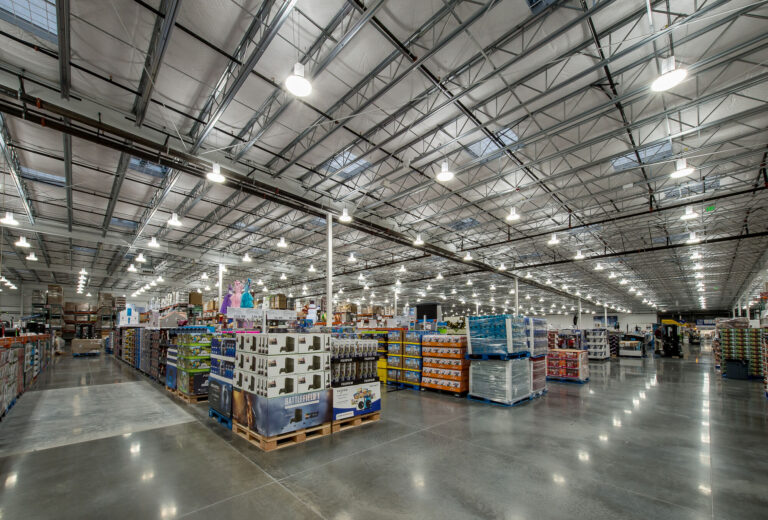 The Costco Warehouse in Bellingham, WA, features high ceilings and bright lighting that provide an ideal environment for showcasing the efficient work of electricians. These professionals ensure the smooth operation of lighting and electrical systems throughout the expansive aisles stocked with bulk goods.