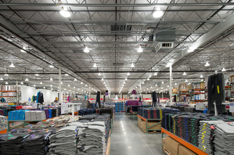 A well-lit warehouse in Bellingham, WA, featuring high ceilings and metal beams, ideal for electrician services.