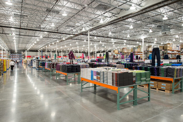 The Costco Warehouse in Bellingham, WA, features a well-lit interior with numerous overhead lights illuminating the shelves. For professional electrician services in Vancouver, WA, contact our experts to ensure efficient and safe lighting installations.