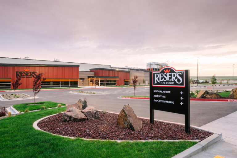 Reser Fine Foods features a distinct red and brown exterior. A clear sign directs visitors to the office, recruiting center, and employee parking areas. If you require electrician services for outdoor lighting or signage installation at similar locations, our team in Vancouver is ready to assist.