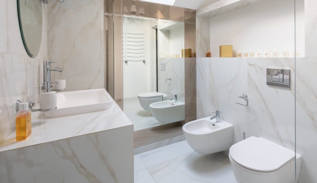 A contemporary bathroom in Vancouver, WA, fitted with pristine white walls and marble floors by our local electricians.