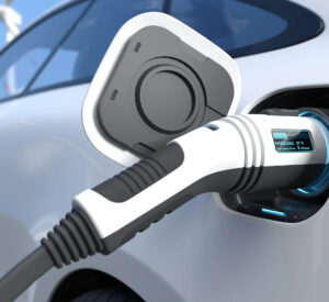 Close-up of an electric vehicle being charged with a plug-in EV charger in Vancouver, WA. The digital display shows the battery at 37% with 3 minutes remaining—demonstrating reliable electrician services for EV charger installation and maintenance.