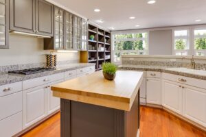 Kitchen in Vancouver, WA with updated island outlet per electrical code, white cabinets, and granite counters.