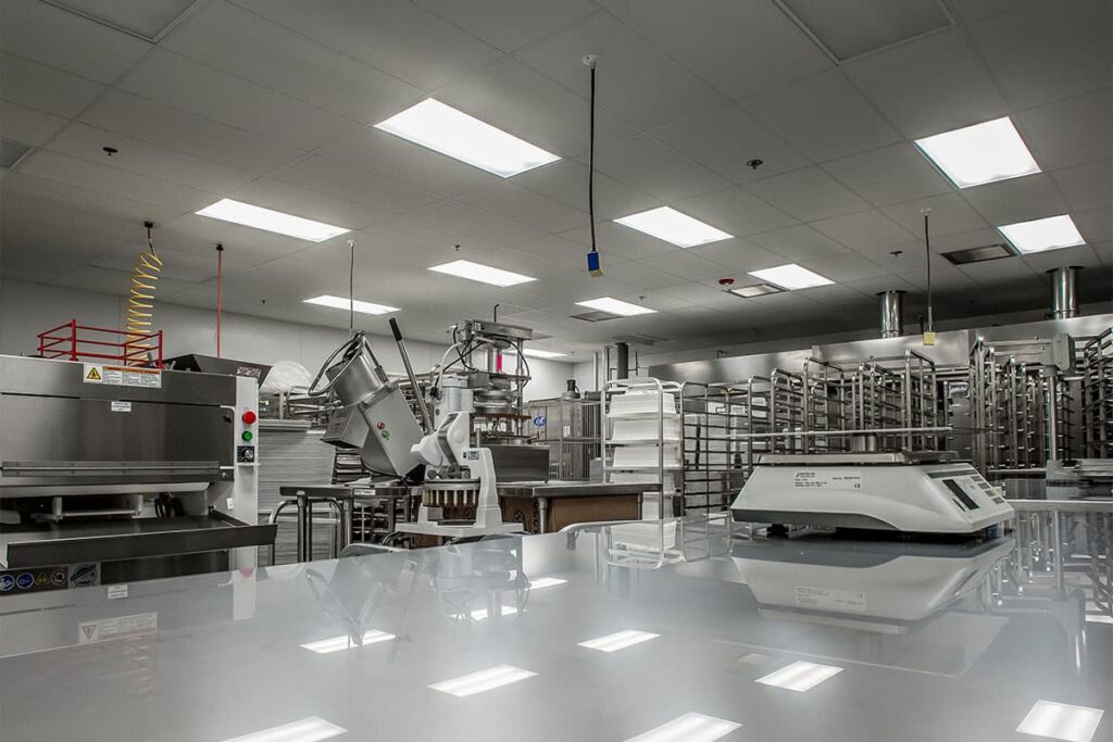 A sizable industrial kitchen with an expansive counter located in Vancouver, WA, all serviced by skilled local electricians.