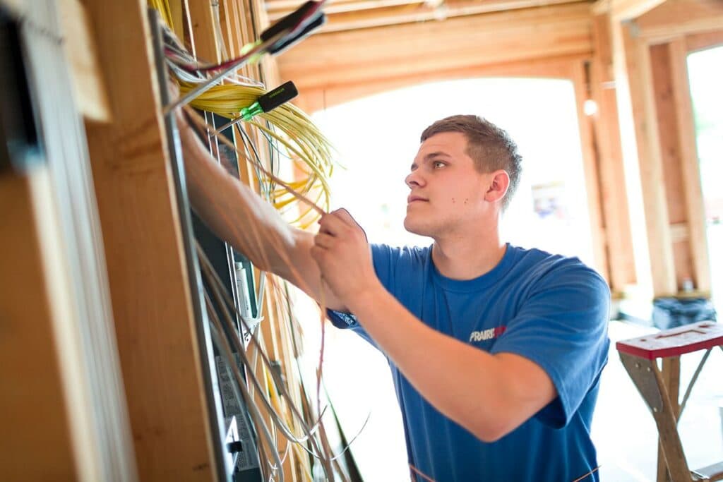 Electrician installing an electrical panel