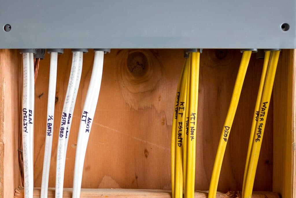 This wooden cabinet filled with electrical wires is a perfect resource for local electricians in Vancouver, WA.