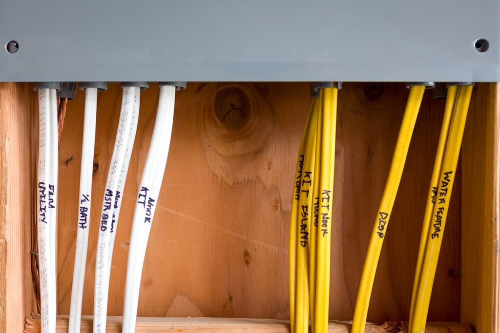 This wooden cabinet filled with electrical wires is a perfect resource for local electricians in Vancouver, WA.