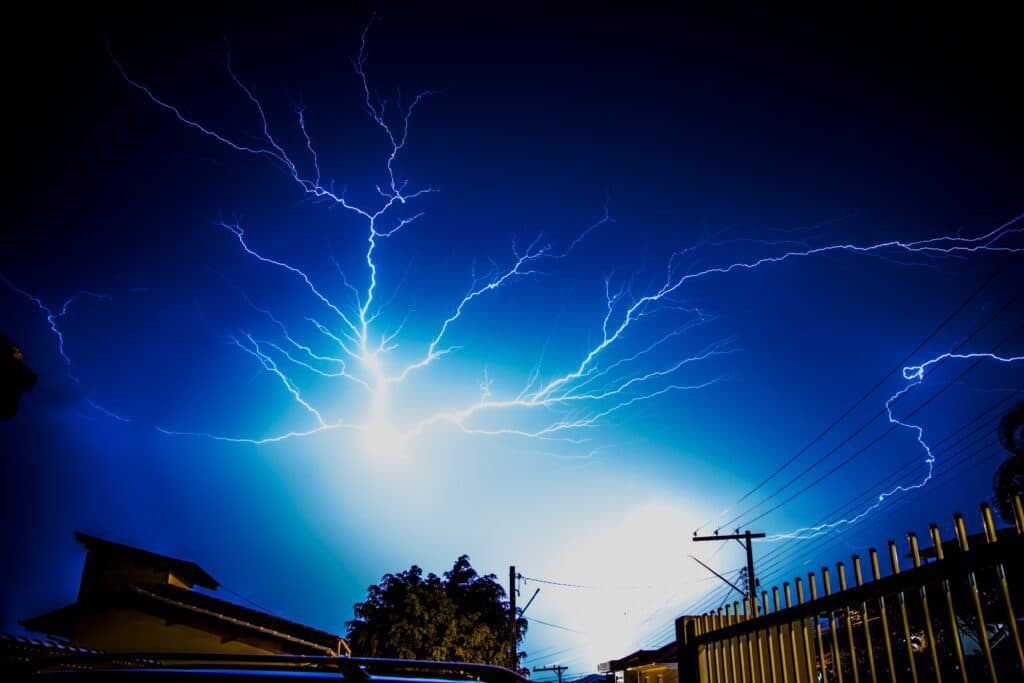 A clear, blue sky above Vancouver, WA gets interrupted by a single lightning bolt, highlighting the incredible power of electricity that our local electricians are able to harness safely and effectively.