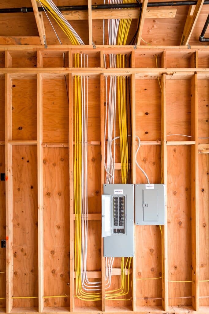 A local electrician from Vancouver, WA installed electrical wiring in a house with wood framing.