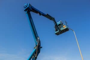 electrician in crane basket works on a streetlight to illustrate Subdivision Electrical Design Full-Service Capabilities