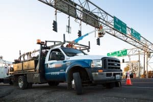 Prairie Electric trucks working on overhead street signs to illustrate subdivision electrical design