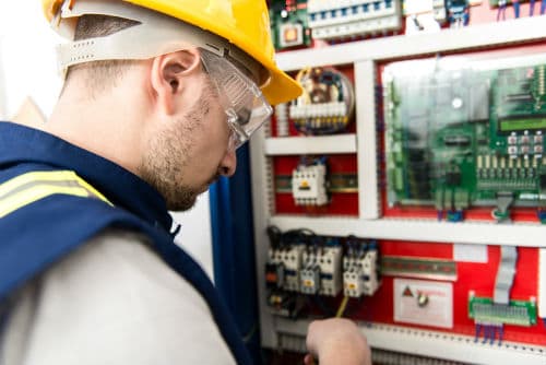 An electrician working on an industrial electric project in Portland OR 